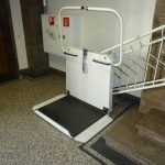 Picture of the stair lift at the foot of the stairs.