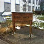 Wooden sign indicating the entrance