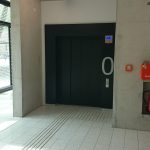 picture of the wheelchair accessible lift doors and tactile guiding system leading up to them on the ground floor